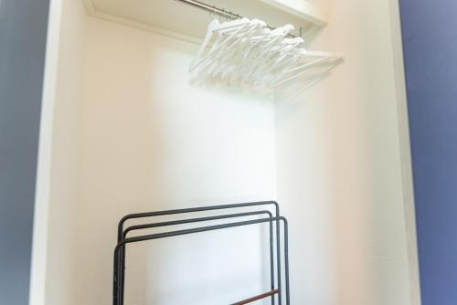 a shelf with a mirror in a white wall at Villa Ray Miyakojima in Hirara
