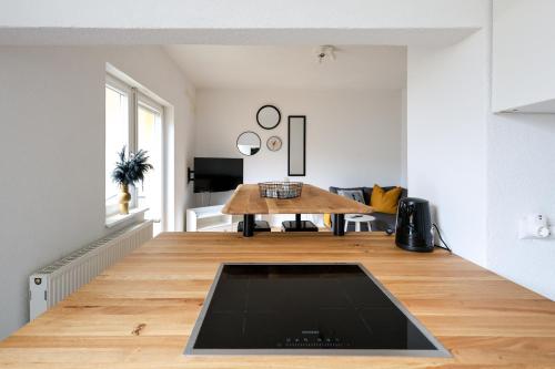 a living room with a wooden table on a wooden floor at Apartment mit Garage und Balkon nähe Europapark in Offenburg