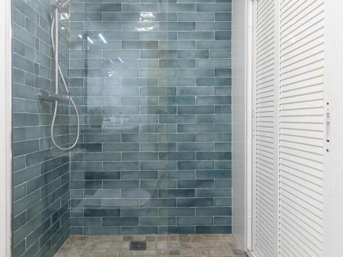 a bathroom with a shower with blue tiles at Terraza de Triana in Seville