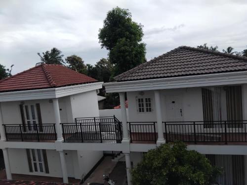 two white houses with balconies on them at Illumination Stay in Negombo
