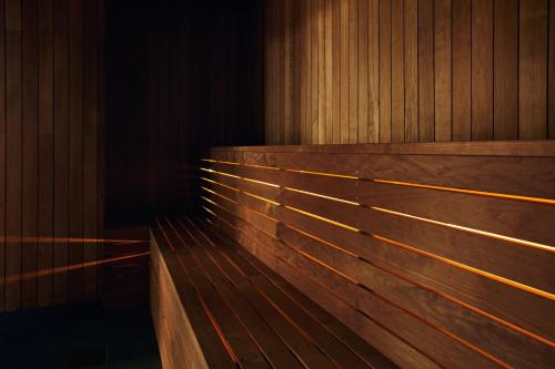 a row of wooden benches in a room at Riddergaarden Mountain Lodge, Beitostølen in Beitostøl