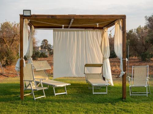 a group of chairs sitting under a gazebo at Bellavita and pool in Brindisi