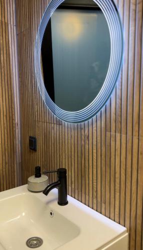 a bathroom with a sink and a mirror at Complex A Toplita in Topliţa