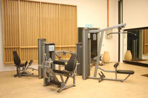a gym with several exercise equipment in a room at Studio with Amazing KLCC View & Infinity Pool at Lalaport Bukit Bintang in Kuala Lumpur