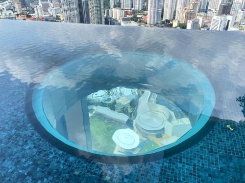 an aerial view of a swimming pool in a city at Studio with Amazing KLCC View & Infinity Pool at Lalaport Bukit Bintang in Kuala Lumpur