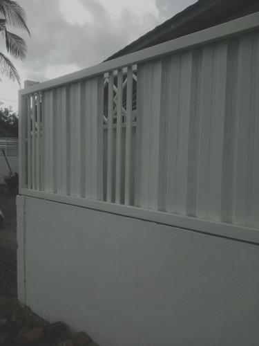 a white wall with a window on top of it at Rumah Putih Edi in Sengkol