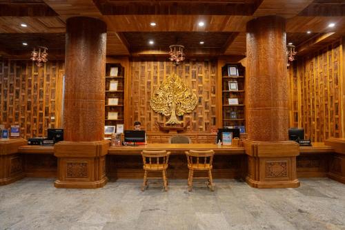 a library with columns and a desk with chairs at Santhiya Koh Chang Resort in Ko Chang
