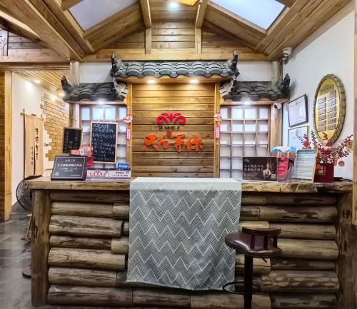 a restaurant with wooden walls and a counter at Just waiting for you-Tianmen mountαin-English reception-Book ticket service in Zhangjiajie