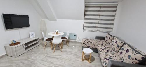 a living room with a couch and a table at Apartman Vuk Zlatar in Brdo