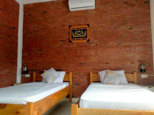 Кровать или кровати в номере Rumah Pantai Krui