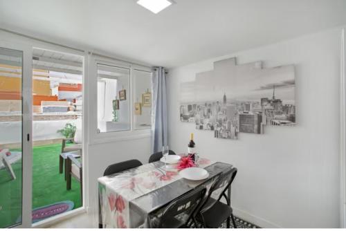 a dining room with a table and a window at Villa Monica in Agüimes
