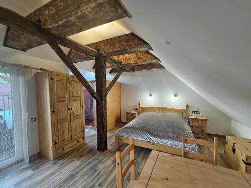 a bedroom with a large bed in a attic at Vířivka a sauna na pokoji,nebo na vlastní terase - Farma u Příbrami in Příbram