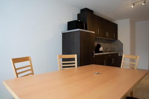 a kitchen with a wooden table and chairs at Haus Forellenhof in Ischgl