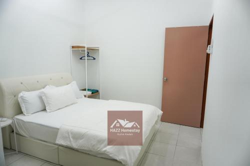a room with a bed with a sign on it at HAZZ Homestay Puncak Ihsan in Kulim