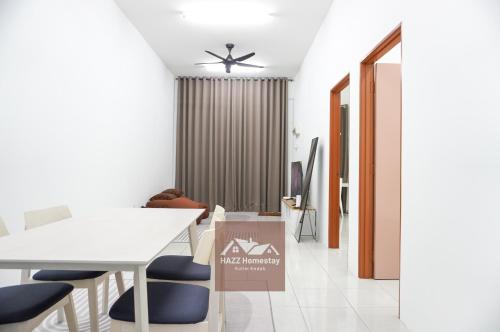 a dining room with a white table and blue chairs at HAZZ Homestay Puncak Ihsan in Kulim