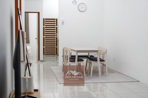 a dining room with a table and two chairs at HAZZ Homestay Puncak Ihsan in Kulim