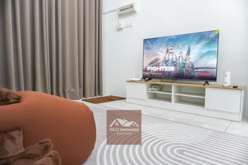 a living room with a flat screen tv at HAZZ Homestay Puncak Ihsan in Kulim