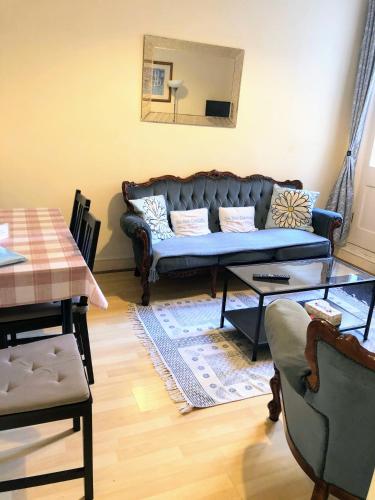 a living room with a couch and a table at Spacious West London 2 Bedroom Apartment in London