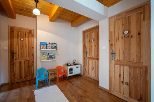 a room with wooden doors and a table and chairs at Chata Bystrá in Mýto pod Ďumbierom