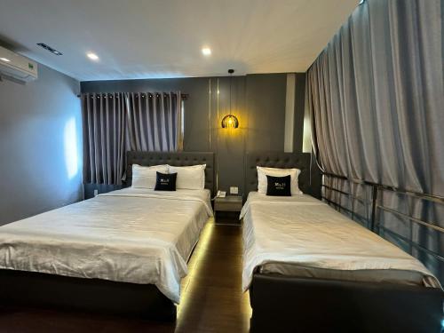 Postel nebo postele na pokoji v ubytování M&H Lux Hotel