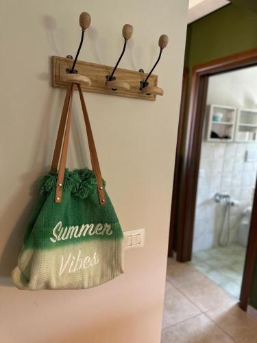 a green towel hanging on a wall in a bathroom at Agriturismo il maniero in Ancona