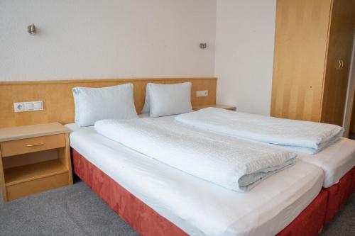 a bedroom with two beds and a nightstand with at Haus Forellenhof in Ischgl