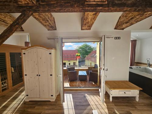 a kitchen with a door open to a patio with a table at Vířivka a sauna na pokoji,nebo na vlastní terase - Farma u Příbrami in Příbram