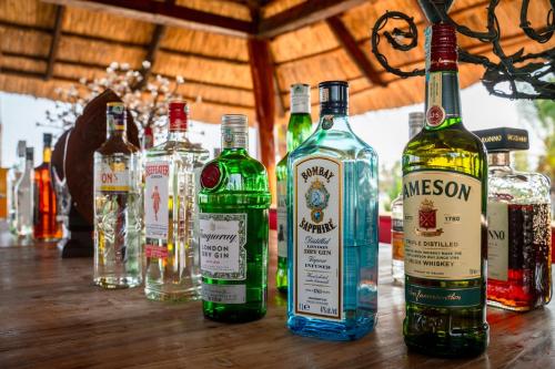 a group of bottles of alcohol sitting on a table at Maharaja Boutique Hotel Zanzibar in Uroa