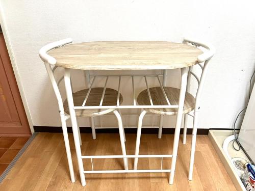 a small white table with two stools under it at 8min walk from Namba Station for 4 people gran704 in Osaka