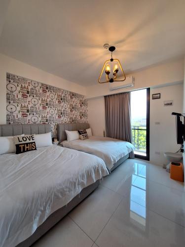 a bedroom with two beds and a chandelier at Villa Ten - Catch up in Guilin