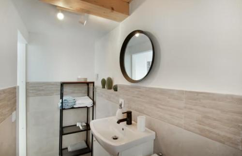 a white bathroom with a sink and a mirror at Villa Monica in Agüimes