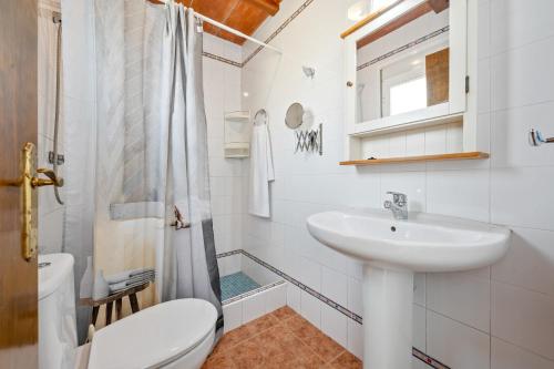 デルテブレにあるCaseta Montanyanaの洗面台とトイレを備えた白いバスルーム