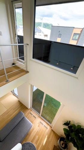 two views of a living room with two windows at HiL town yamanashi 12 MSDG in Kofu