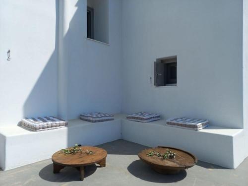 a room with two benches and a tv on a wall at Skyros BnB ANNA House in Brooke in Skiros