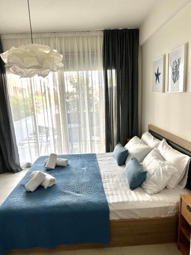 a bedroom with a large bed with two towels on it at La Scala Nikiti in Nikiti