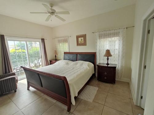a bedroom with a large bed and a window at Colibri Court Antigua in Jolly Harbour