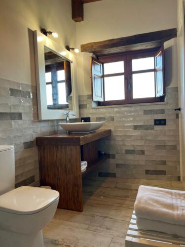 a bathroom with a sink and a toilet at Ca La Gràcia in Cabrianas