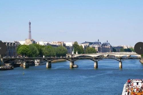 a bridge over a river in a city at Villa arborée aux Portes de Paris in Bobigny