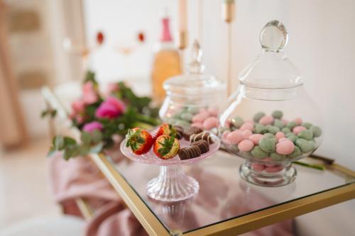 a glass table with cookies and strawberries in a glass jar at Casa Apuliae Bed & breakfast in Bitonto