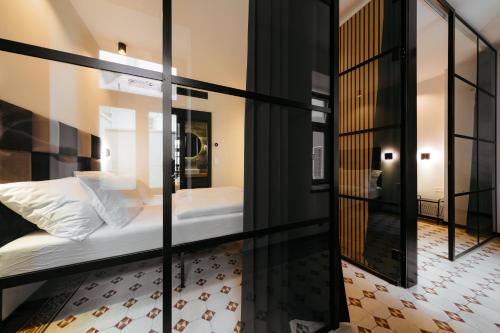 a room with a bed and a mirror at Main Square Apartments & Rooms in Maribor