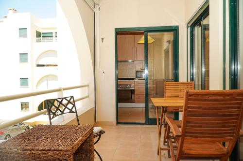 a kitchen and dining room with a table and chairs at Salgados Apartment in Albufeira