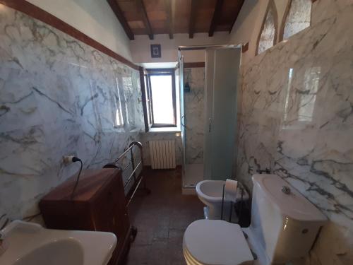 a bathroom with two sinks and two toilets at PERGOLA at Le Pietraie a cottage with many flowers in Montecastelli Pisano