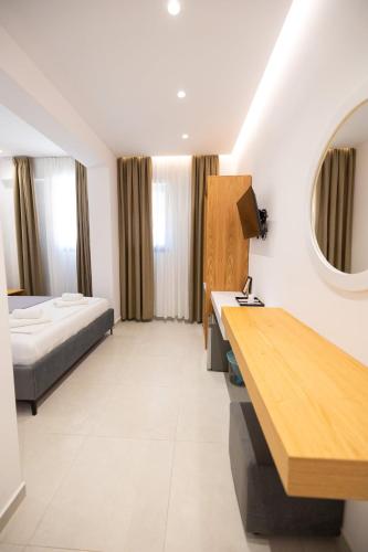 a hotel room with a bed and a desk in it at Villa The Old Bakery in Qeparo
