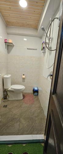 a bathroom with a toilet and a shower at The Hideout in Suva