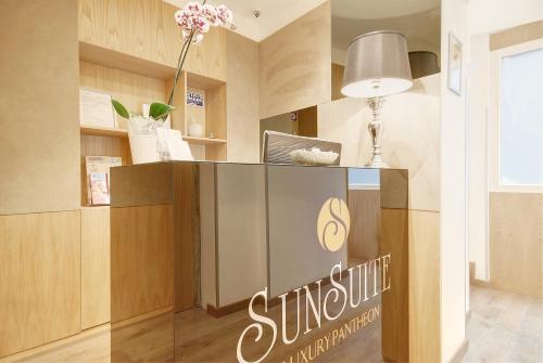 a sign for a sunsplithsuranceurance office in a room at Sun Suite Luxury Pantheon in Rome