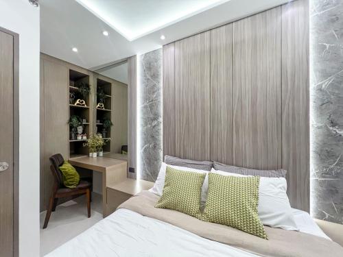 a bedroom with a large bed and a desk at Staycation at Camella Manors Verdant Palawan in Puerto Princesa City