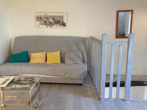 a living room with a couch and a table at Maison bord de rivière in Roquestéron