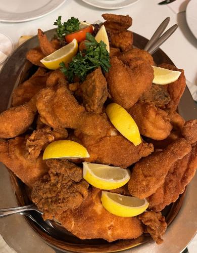 a plate of food with fish and lemon slices at Ferienhaus Sausalblick in Großklein
