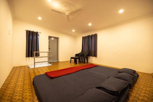 a bedroom with a large bed in a room at Sri Sai Holiday Inn in Puducherry