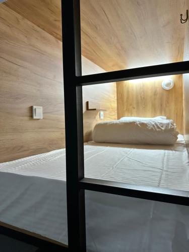 a view through a glass window of a bedroom at Hostel O2 in Almaty